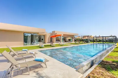 a swimming pool in the backyard of a house at Spacious villa with jacuzzi and activities in Marrakech