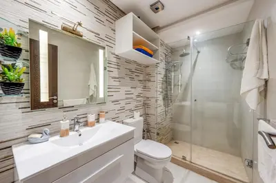 a bathroom with a toilet and a sink and a shower at Luxe City Escape 2BR Pool in Marrakech