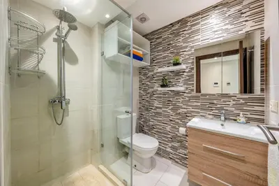 a bathroom with a shower and a toilet and a sink at Luxe City Escape 2BR Pool in Marrakech