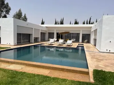 a large swimming pool in front of a house at Villa Zaara in Sehib Foukani