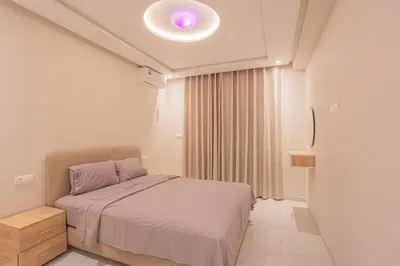 a bedroom with a bed with a purple light on the ceiling at Cosy & Modern Apartment Near Jardin Majorelle, Marrakech in Marrakech