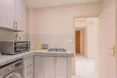 a kitchen with a sink and a microwave at Cosy & Modern Apartment Near Jardin Majorelle, Marrakech in Marrakech