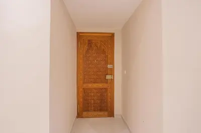 a hallway with a wooden door in a room at Cosy & Modern Apartment Near Jardin Majorelle, Marrakech in Marrakech