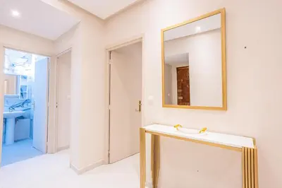 a bathroom with a mirror and a sink at Cosy & Modern Apartment Near Jardin Majorelle, Marrakech in Marrakech