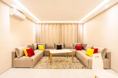 a living room with a couch with colorful pillows at Cosy & Modern Apartment Near Jardin Majorelle, Marrakech in Marrakech