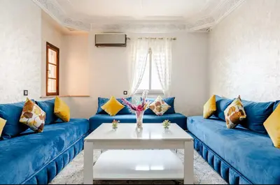 a living room with blue couches and a white table at Princess in Marrakech