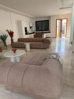 a living room with two couches and a tv at Villa Wissam in Marrakech
