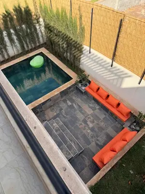 a swimming pool with a green frisbee in it at Villa Wissam in Marrakech