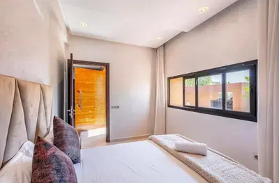 a bedroom with a bed and a window at Luxury 4-ROM Villa with private Heated pool in Akenza ,free Airport transport service in El Rhechat