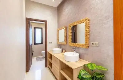 a bathroom with two sinks and two mirrors at Luxury 4-ROM Villa with private Heated pool in Akenza ,free Airport transport service in El Rhechat