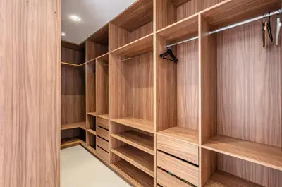 a walk in closet with wooden cabinets at Luxury 4-ROM Villa with private Heated pool in Akenza ,free Airport transport service in El Rhechat