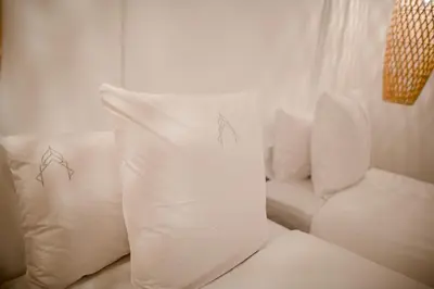 a white couch with two pillows on it at Riad A l'Ombre du Palais in Marrakech