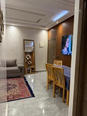 a living room with a table and a couch at appartement Jalal in Marrakech