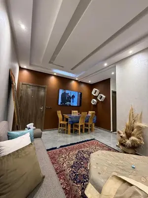 a living room with a couch and a dining room at appartement Jalal in Marrakech