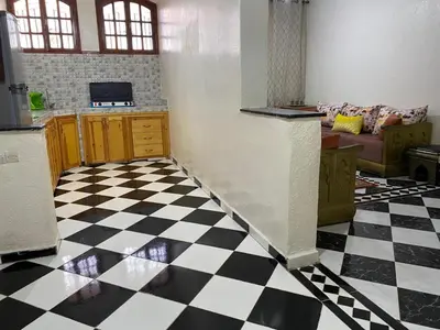 a kitchen with a black and white checkered floor at Garden View Comfort Apartment in Marrakech