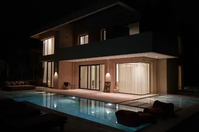 a large swimming pool in front of a building at Villa NAHA in Marrakech