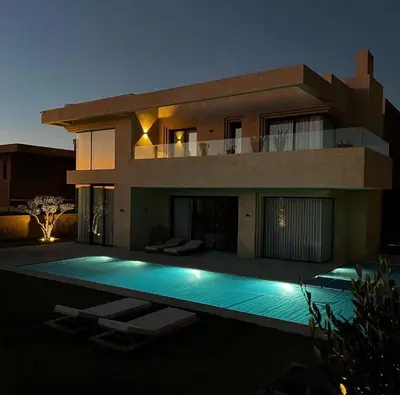 a house with a swimming pool in front of it at Villa NAHA in Marrakech