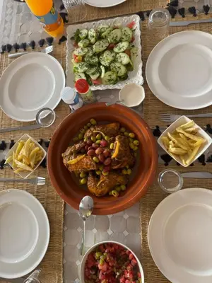 a table with a bowl of food and plates of food at Villa Selma piscine privée sans vis à vis 9 min du centre in Marrakech