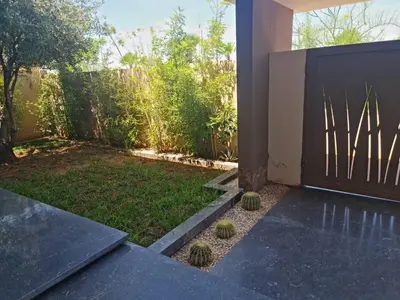 a garden with cacti on the side of a house at Villa Starlight in Marrakech