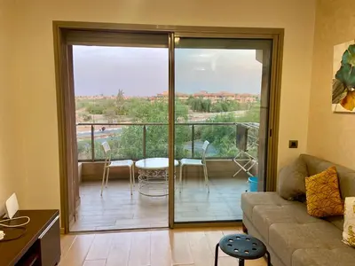 a living room with a couch and a balcony at studio design prestigia jad in Marrakech