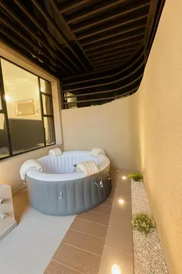a wellness room with a bathtub in the middle of a building at Cozy Appartement avec jacuzzi chauffant in Marrakech