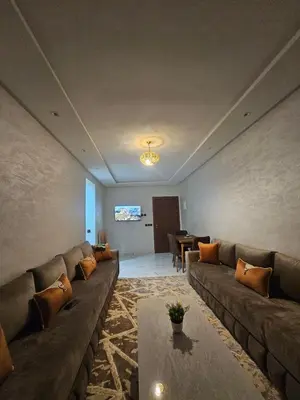a living room with a couch and a table at Central Bright Comfortable in Marrakech