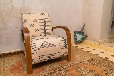 a chair sitting in the corner of a room at Riad Lalla Fatima Marrakech in Marrakech