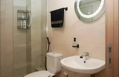 a bathroom with a toilet and a sink and a mirror at Superbe Duplex moderne à Izdihar in Marrakech