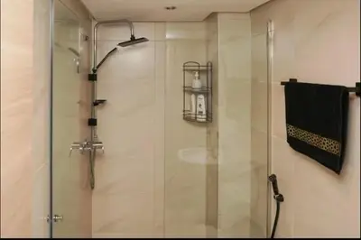 a shower with a glass door in a bathroom at Superbe Duplex moderne à Izdihar in Marrakech