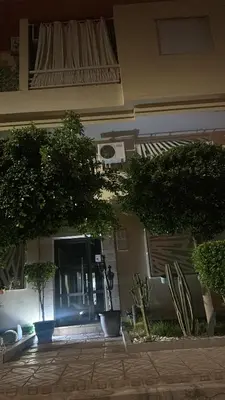 a building with trees in front of a door at Superbe Duplex moderne à Izdihar in Marrakech