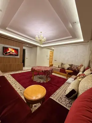 a living room with a couch and a table at حدائق حي شريفية بوعكاز مراكش in Marrakech