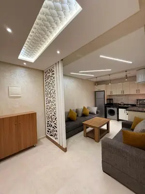 a living room with a couch and a table at حدائق حي شريفية بوعكاز مراكش in Marrakech