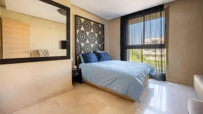 a bedroom with a bed and a large window at Villa de luxe in Marrakech