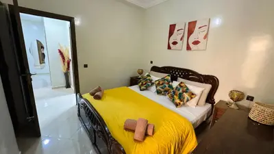 a bedroom with a bed with yellow sheets and pillows at Private Apartment Near Marrakech Airport in Marrakech