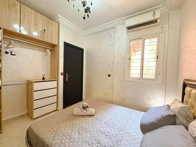 a bedroom with a bed with a towel on it at Elegance and comfort in Marrakech Top Location in Marrakech