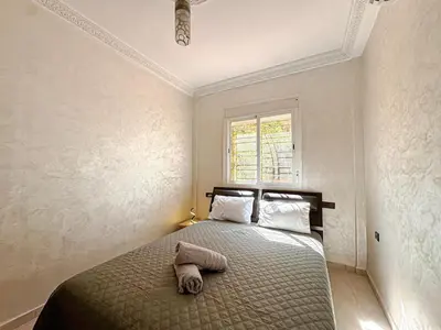 a bedroom with a bed with a towel on it at Elegance and comfort in Marrakech Top Location in Marrakech