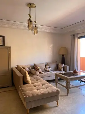 a living room with a couch and a coffee table at Appartement en plein cœur de Marrakech in Marrakech