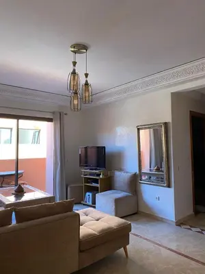 a living room with a couch and a mirror at Appartement en plein cœur de Marrakech in Marrakech