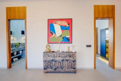 a table in a room with a painting on the wall at Villa joud in Marrakech