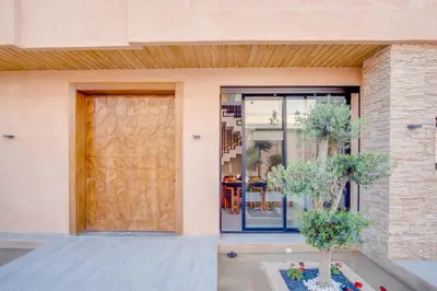 a front door of a house with two trees in front at Villa joud in Marrakech