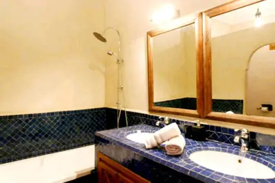 a bathroom with a sink and a mirror at Arabian Riad Marrakech in Marrakech
