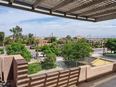 a balcony with a view of a parking lot at marrakech village in Marrakech