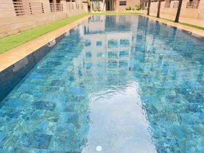 a large swimming pool with blue water at Calm Cozy Blue Loft Modern Stay in Marrakech