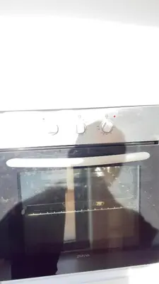 a microwave oven with a reflection of a person in it at Calm Cozy Blue Loft Modern Stay in Marrakech