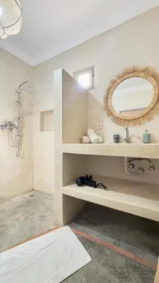 a bathroom with a sink and a mirror at Villa Bella Marrakech avec piscine sans vis-à-vis 9 min du centre in Marrakech