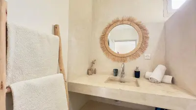 a bathroom with a sink and a mirror at Villa Bella Marrakech avec piscine sans vis-à-vis 9 min du centre in Marrakech