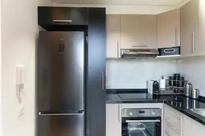 a kitchen with a stainless steel refrigerator at AyaMi Marrakech Luxury Stay in Marrakech