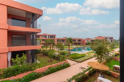 an apartment building with a courtyard and a swimming pool at AyaMi Marrakech Luxury Stay in Marrakech