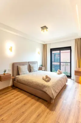 a bedroom with a large bed and a large window at AyaMi Marrakech Luxury Stay in Marrakech