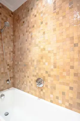 a shower in a bathroom with a tile wall at Marrakech Palmeraie 2, 2-bedroom appartment, G1 , swimming pool residence, in Marrakech